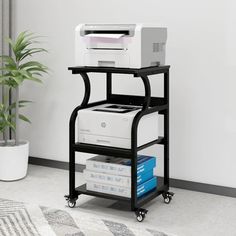 a printer is sitting on top of a cart