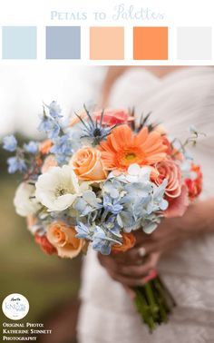 a bride holding a bouquet of orange and blue flowers