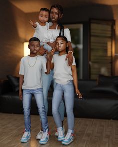 a group of people standing next to each other on a wooden floor in front of a couch