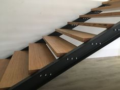 a set of wooden stairs with metal handrails