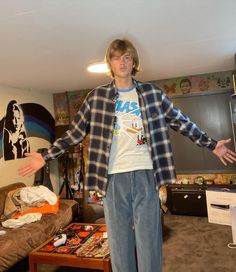 a man standing in the middle of a living room with his hands out to someone