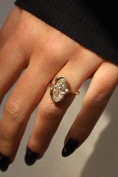 a woman's hand with a diamond ring on it