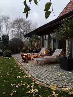 the patio is lit up with candles and lights on it, as well as lawn chairs