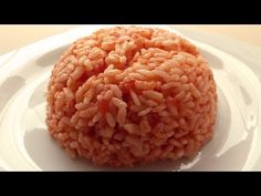 a white plate topped with rice on top of a table