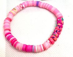 Add a pop of color and a touch of charm to your wrist with this handmade polymer clay beaded bracelet. This lovely piece features a perfect blend of pink and purple spacer beads, creating a delightful contrast that will add a playful and feminine flair to any outfit. Whether you're looking for a unique accessory for yourself or a thoughtful gift for a friend, this friendship bracelet is sure to bring joy and sweet style to your day. Made with care and attention to detail, each bead is uniquely crafted to ensure a one-of-a-kind piece that you'll love to wear on repeat. Clay Beaded Bracelet, Polymer Clay Beads, Sweet Style, On Repeat, Pink And Purple, Clay Beads, Handmade Polymer Clay, Accessories Unique, Friendship Bracelet