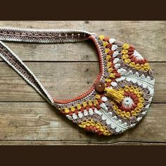 a crocheted purse sitting on top of a wooden floor