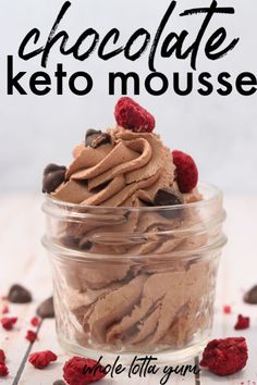 chocolate keto mousse in a glass bowl with raspberries