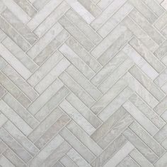 a white marble herringbone tile pattern