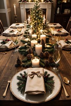 a dining room table set for christmas with candles, plates and napkins on it