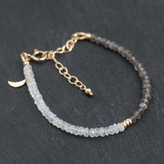 Beautiful AAA grey & white moonstone bracelet   D E T A I L S △ Handmade in Vancouver △White Moonstone & Grey Moonstone △ Sterling Silver accents & clasp OPTIONAL △ 14K Gold filled findings OPTIONAL △ Gold vermeil crescent moon OPTIONAL △ Extender for perfect fit (6-8") △ Gemstones are 100% genuine  G E M S T O N E I N FO  Moonstone: intuition, inspiration, abundance L E N G T H 6-8" ♡ Q U A L I T Y  The upmost quality and care goes into sourcing each and every material I use. Gemstones are sour Luxury Moonstone Gemstone Bracelets, Gold Bracelet Moonstone, Minimalist Handmade Moonstone Beaded Bracelets, Handmade Dainty Moonstone Beaded Bracelets, Handmade Minimalist Moonstone Beaded Bracelet, Minimalist Handmade Beaded Bracelet With Moonstone, Minimalist Handmade Moonstone Beaded Bracelet, Handmade Minimalist Moonstone Bracelets, Minimalist Handmade Moonstone Bracelets