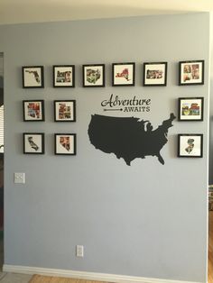 a wall with many framed pictures on it and the words adventure awaits written in black