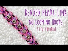 a pink and black braided heart link bracelet with no loom beads on it