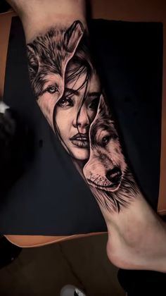 a woman with two wolfs on her arm and one is holding the other's head