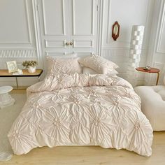 a bed with white sheets and pillows on top of it in a room filled with furniture