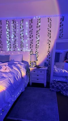 a bedroom decorated in white and blue lights