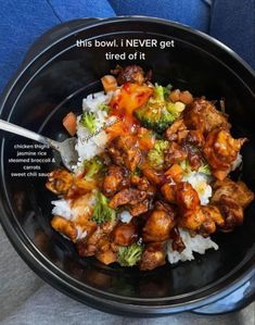 a black bowl filled with rice and meat