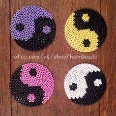 four beaded coasters with different designs on them