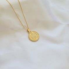 Round gold coin medallion necklace. Double sided medallion coin. Wear it on it's own or layer it. Pendant details: * Finish: non tarnish gold filled * Measurements: 1'H 0.7'WChain: non tarnish gold filledComes in our gift ready packaging: vegan leather pouch for safe jewelry storing and branded box Saint Benedict, Figaro Chains, Medallion Necklace, Gold Coin, Necklace Box, Gold Coins, Leather Pouch, Everyday Jewelry, Box Chain