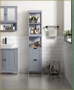 a bathroom with white tile and gray cabinets