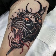 a black and grey tattoo with an animal's head on it