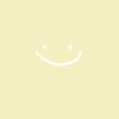 a yellow background with a smiley face drawn on the bottom right corner, and two small white dots in the middle