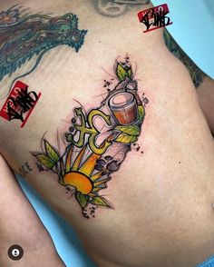 a woman's stomach with tattoos on it and an image of a dragon holding a beer