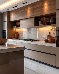 a modern kitchen with marble counter tops and stainless steel appliances