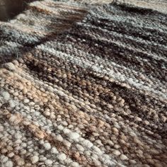 the texture of an area rug is brown and white