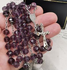 A beautiful vintage French rosary, in good condition, comes with nice solid silver cross crucifix. Rosary measures approx. 50 cm (20 inch) in length and has nice purple glass faceted beads which are all intact and very pretty. The connector is with Mother Mary, this interesting rosary would make a nice gift for someone special or a collector. Box on photos is NOT included! A stunning religious jewelry shop well worth a visit ... https://www.etsy.com/shop/100saints. PLEASE LOOK AT THE PICTURES, T Silver Faceted Beads Rosary Cross, Faceted Beads Crucifix Rosary As Gift, Gift Rosary With Polished Beads And Cross, Gift Rosary With Polished Beads, Spiritual Cross Rosary With Faceted Beads, Rosary With Faceted Beads And Crucifix, St Benedict Medal, St Peter And Paul, Jesus Necklace