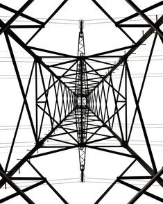 an image of high voltage power lines in black and white photo, taken from below