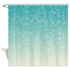 a shower curtain with blue and white glitters on the outside, in front of a white