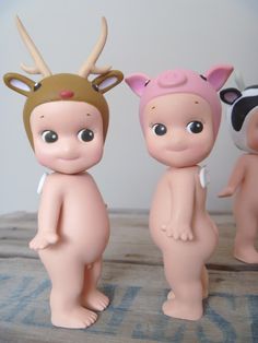 three small toy animals standing next to each other