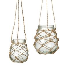 two glass jars with rope hanging from them