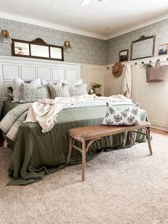 a bedroom with a large bed and green comforter on it's coverlet