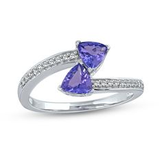 Bring dreamy colour and elegant detail to any look when you wear this trillion-cut tanzanite and diamond bypass ring in white gold. Created in cool 10K white gold Two 5.0mm trillion-cut violet-blue tanzanites glisten in a mirrored design at the centre - one punctuating each side of the bypass design. Diamonds shimmer along the shank. This toi et moi ring sparkles with 0.086 ct. t.w. of diamonds. Trillion Diamonds, Gold Book, Tanzanite Stone, Bypass Ring, Peoples Jewellers, Sparkling Rings, Wrap Ring, Wrap Rings, Diamond Stone