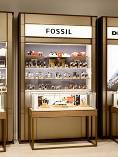 two display cases with different types of items on them in front of a store window