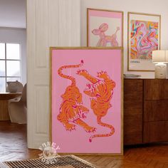 there are two paintings on the wall and one is pink with orange tiger designs in it