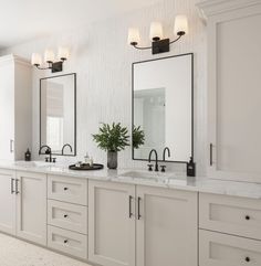 a large bathroom with two sinks and mirrors