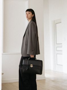 Editor's NotesFELLO's accessory is unique and perfect for everyday wear.- Light-weighted modern briefcase bag- Eye-catching leather texture- Good storage of capacity- Vintage and minimal style- Daily point itemMeasurements(in.)- Size: 14.6in. (W) * 10.2in. (H) * 3.5in. (D)Composition & Care- Cow leather- Avoid direct heat and moisture- Professional cleaning is recommendedDesigner- by FELLO Timeless Structured Satchel For Work, Timeless Structured Workwear Satchel, Timeless Structured Shoulder Bag For Work, Minimalist Leather Shoulder Bag For Work, Minimalist Satchel With Top Carry Handle For Work, Timeless Structured Bags For Work, Timeless Structured Shoulder Bag For Business, Timeless Structured Workwear Bags, Elegant Structured Workwear Satchel