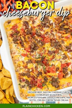 the bacon cheeseburger dip is in a white casserole dish surrounded by tortilla chips