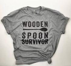 Womens sizes RUN SMALL. We recommend ordering 1-2 sizes up, or going with a unisex size, for the best fit. - Digitally printed with eco-friendly, water-based inks on a Next Level Premium Heather Grey tri-blend unisex t-shirt - Super soft tri-blend 50% cotton, 25% polyester, 25% rayon Wooden Spoon Survivor, Funny Shirt Sayings, Vinyl Shirts, Funny Mom Shirts, Wooden Spoon, T Shirts With Sayings, Funny Shirt, Mom Humor, Shirts With Sayings