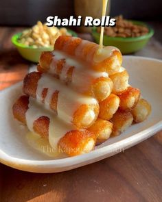 food on a white plate with the words shai rolls in front of it and other foods