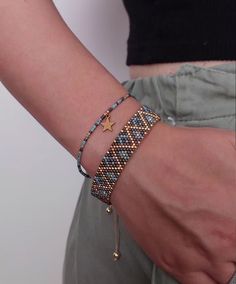 a close up of a person's arm wearing a bracelet with stars on it