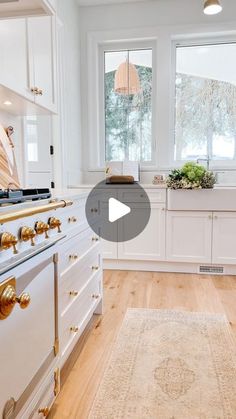 a kitchen with white cabinets and wood floors is featured in the video for this article