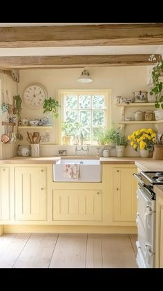 a kitchen filled with lots of yellow cabinets and counter top space next to a window