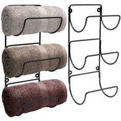 three towels are hanging on two metal racks