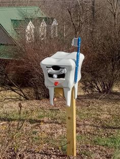 a white mailbox sitting on top of a wooden post