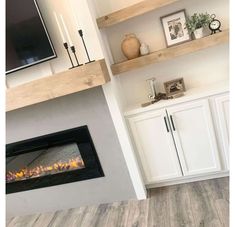 a living room with white cabinets and a fireplace