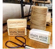 several different types of soaps and scissors on a table with twine spools