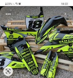 yellow and black graphics on the side of some wooden pallets for dirtbikes